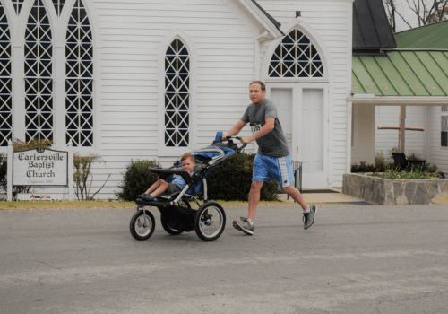 Father Running with His Son in a Stroller in the Second Chance Mission Run 5k